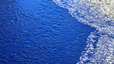 ice melting from blue color surface, fusion time lapse view