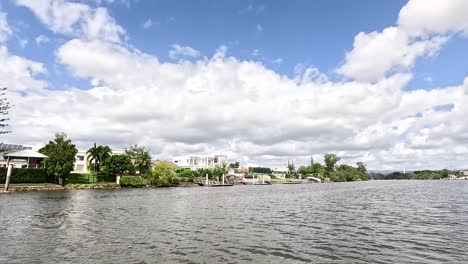 peaceful river scene with luxury homes visible