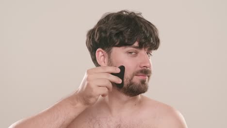 man performing gua sha facial massage
