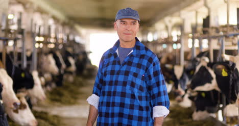 thoughtful mature male farmer using digital tablet