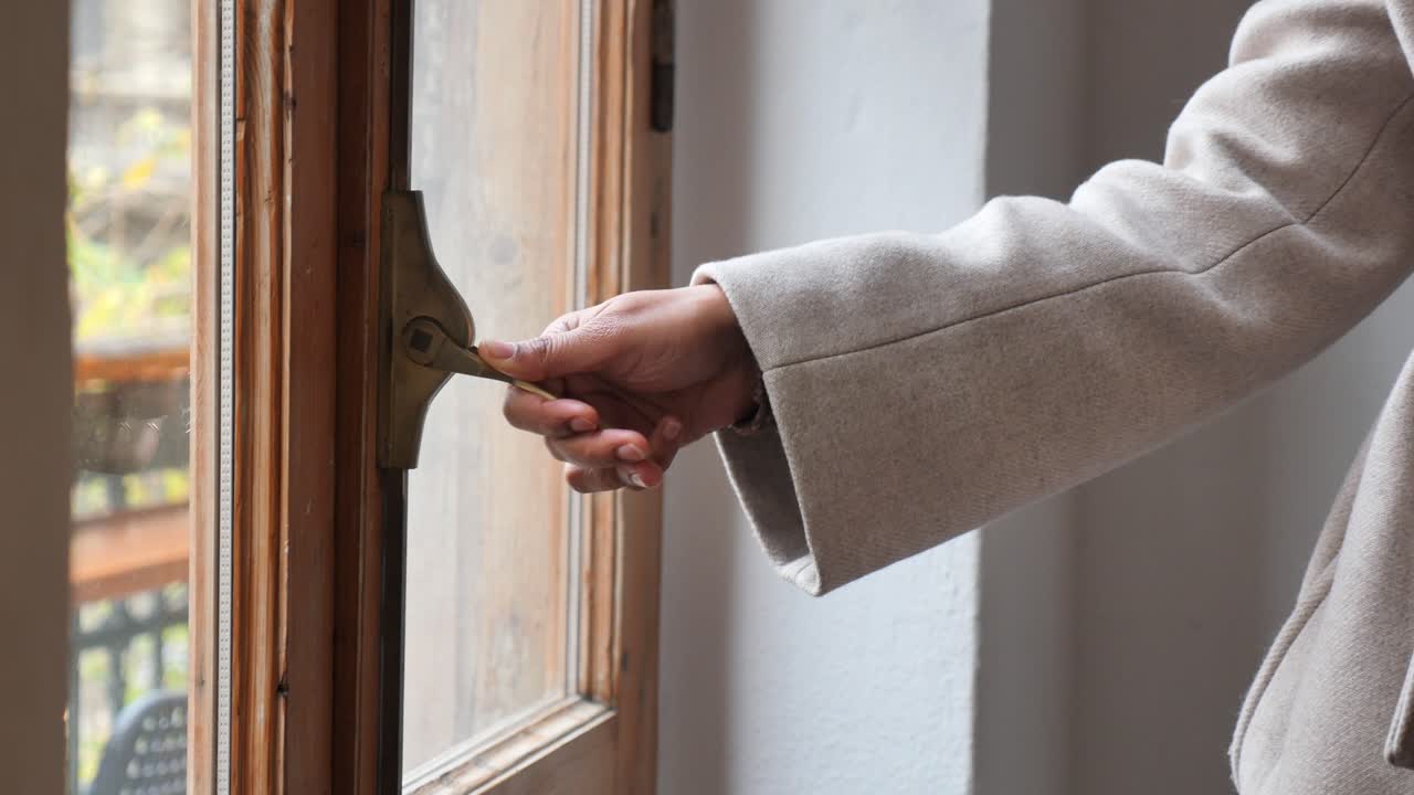 Person's Hand Opening and Closing a Wooden Window Latch