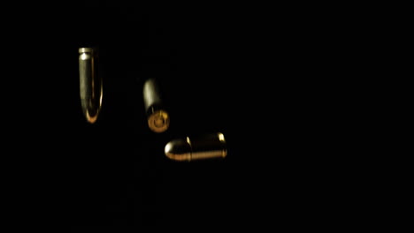 9mm-Parabellum-Bullets-Falling-Slowly-Against-Dark-Background