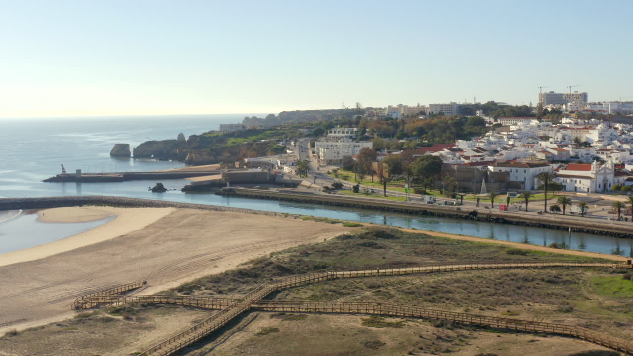 Lagos Portugal cliffs beach river – aerial cityscape 4K