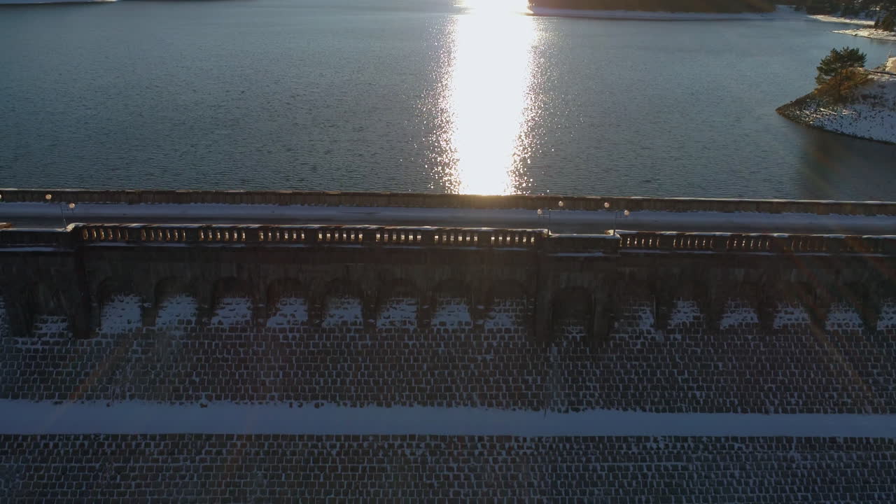 Aerial View of a Snow-Covered Dam at Sunset