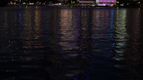 skyscrapers reflecting on water at night