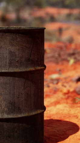 rusty metal barrel in a desert landscape