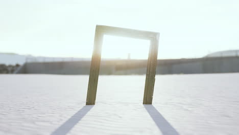 empty wooden picture frame on the beach sand