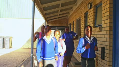 schoolchildren running in the playground at a township school 4k