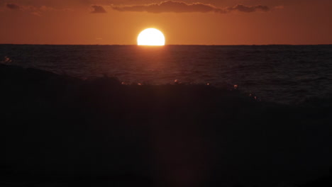 time lapse shot of sun setting behind ocean waves 1