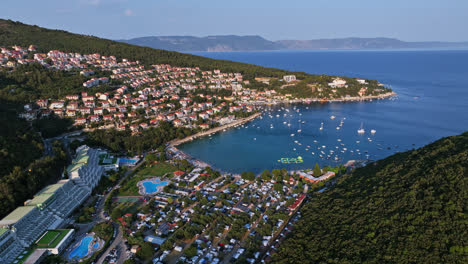 vuelo aéreo alrededor de la ciudad y complejo de rabac, noche soleada en istria, croacia