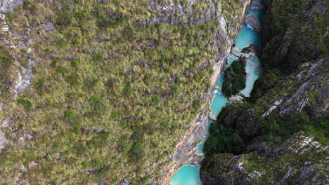 amazing drone shot discovering a beautiful and magical lake called millpu with turquoise waters during a morning located between mountains with vegetation in ayacucho, peru