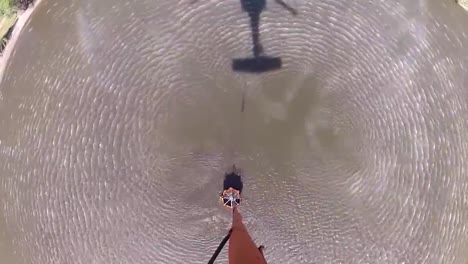 pov from a water dropping helicopter flying over a fire 1