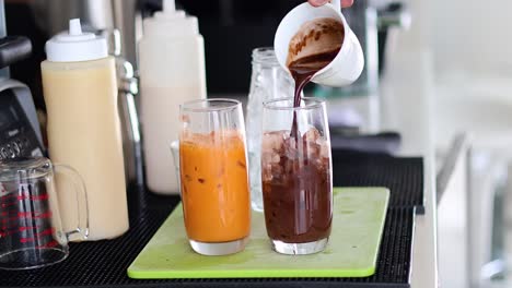 pouring and mixing iced coffee in a glass