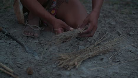 closeup of an ethnic person making a fire in nature