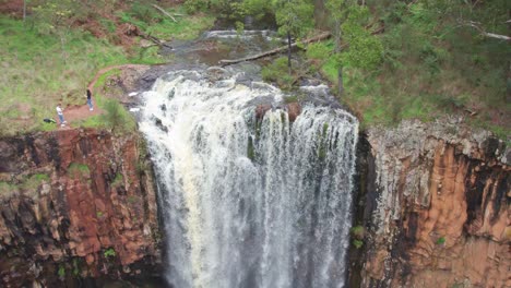 panning down view of water flowing over the trentham falls after rain on 22 sepember, 2021, victoria, australia