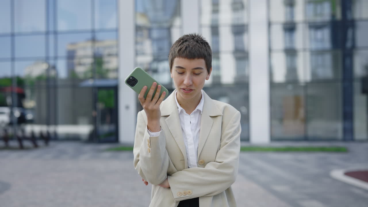 Businesswoman talking on her smartphone outside an office building