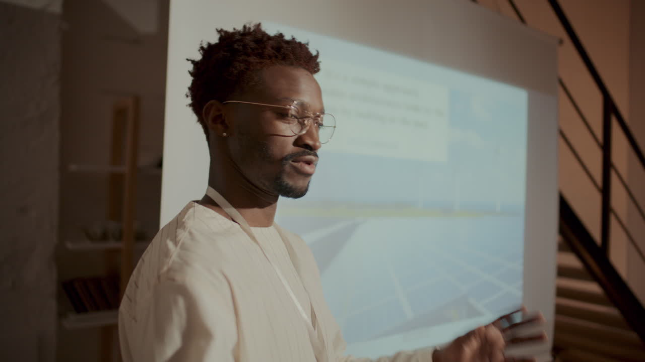 Young Man Giving Presentation on Energy Efficient Architecture during Seminar