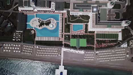 aerial view of luxurious resort with swimming pools and beach