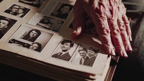 close-up of an elderly hand touching a vintage photo album, evoking nostalgia