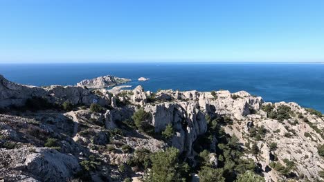 panoramic view of limestone cliffs and offshore islands in les calanques national park near marseille, france with mediterranean sea and clear blue sky