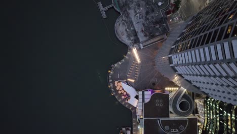 Topdown-aerial-shot-of-Brisbane-City's-Eagle-Street-Pier-boardwalk-at-night-time