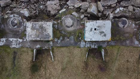 aerial birdseye view of abandoned seaside fortification building at karosta northern forts on the beach of baltic sea in liepaja in overcast spring day, drone shot moving forward