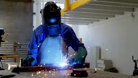 Female-welder-using-blow-torch-on-a-rod-4k