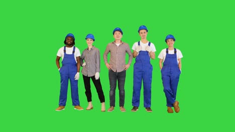 group of architects, engineers, workers at a construction site smiling on camera on a green screen, chroma key