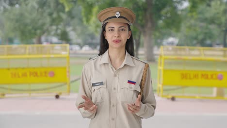 happy indian female police officer talking