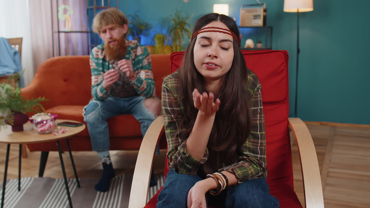 Aggressive woman talking to camera about quarreling with man at home conflict at family couple