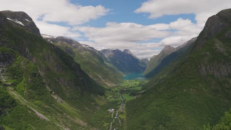 Oldevatnet-lake-surrounded-by-lush-green-mountains-in-norway,-aerial-view