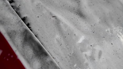 car being washed with foamy soap close-up