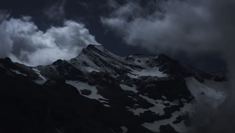 mountain peak under stormy clouds
