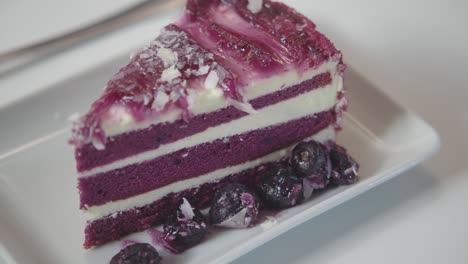 purple red velvet cake slice with blueberries