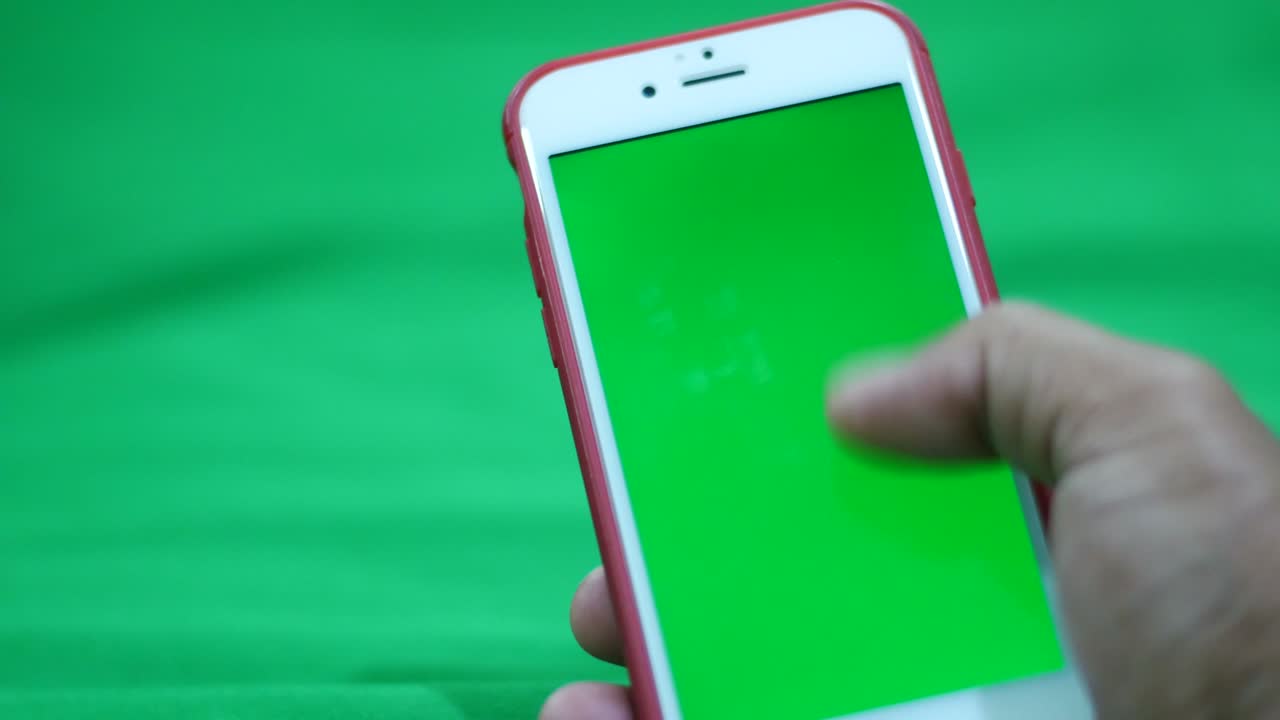 Hands holding and using a mobile phone  green screen