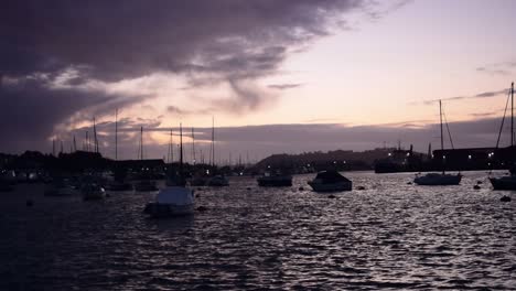 the sun setting over the boats