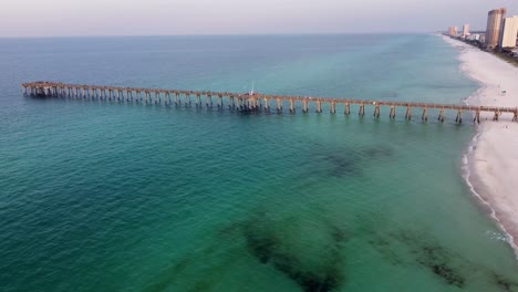 Panama-city-beach-Pier-at-Pier-park-Aerial-view-during-morning-dawn,-clear-water-beach-of-Panhandle-Florida-America