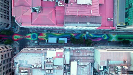 aerial view looking down at colourful paseo bandera pedestrian street floor mural in downtown santiago, chile