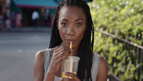 slow motion portrait of happy beautiful african american woman drinking juice