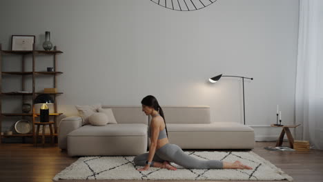 woman stretching in a modern living room