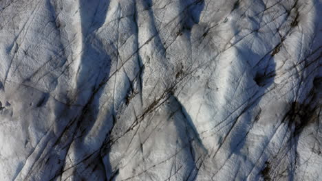 Aerial:-Rising-top-down-view-of-a-glacier-during-a-sunny-day