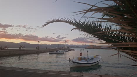 greek fishing boats moored in mediterranean harbour sundown