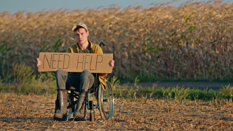 man in wheelchair asking for help in cornfield