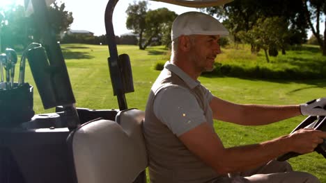 happy golfer driving buggy on the golf course