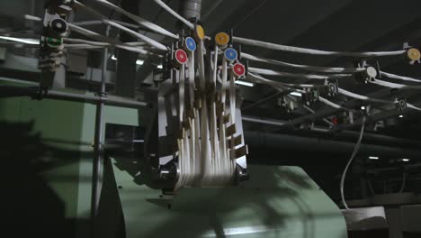 automated spinning machine operating in a textiles production mill