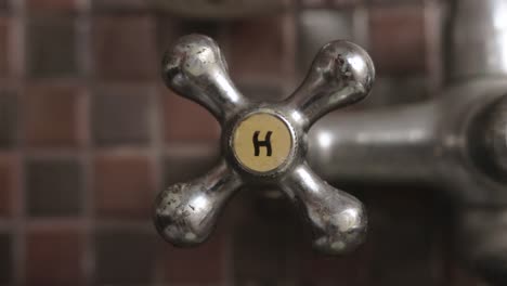 Male-Hand-Opening-and-Closing-Hot-Water-Handle-Faucet-Close-up