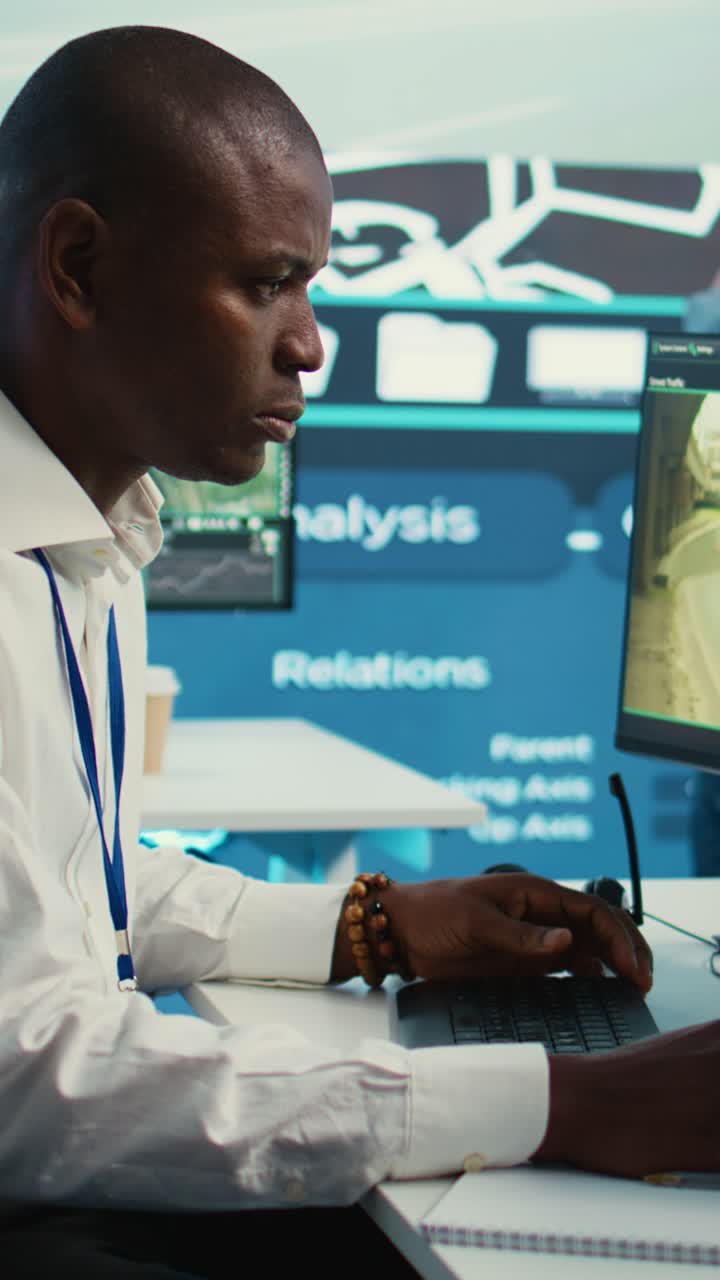 African American Man Monitoring Traffic on Computer in Control Room