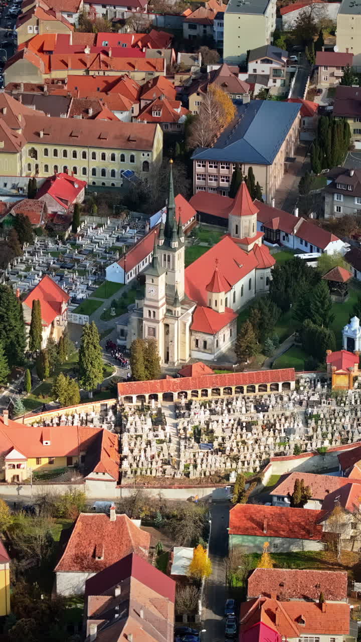 Aerial drone view of the St. Nicholas Church and the First Romanian School Museum in Brasov, Romania. Vertical
