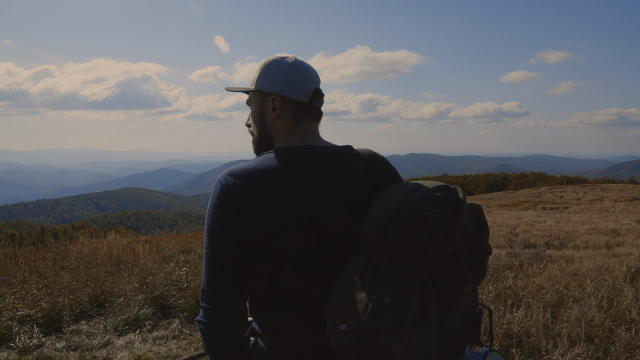 Backpacker and his dog at the top of the hill