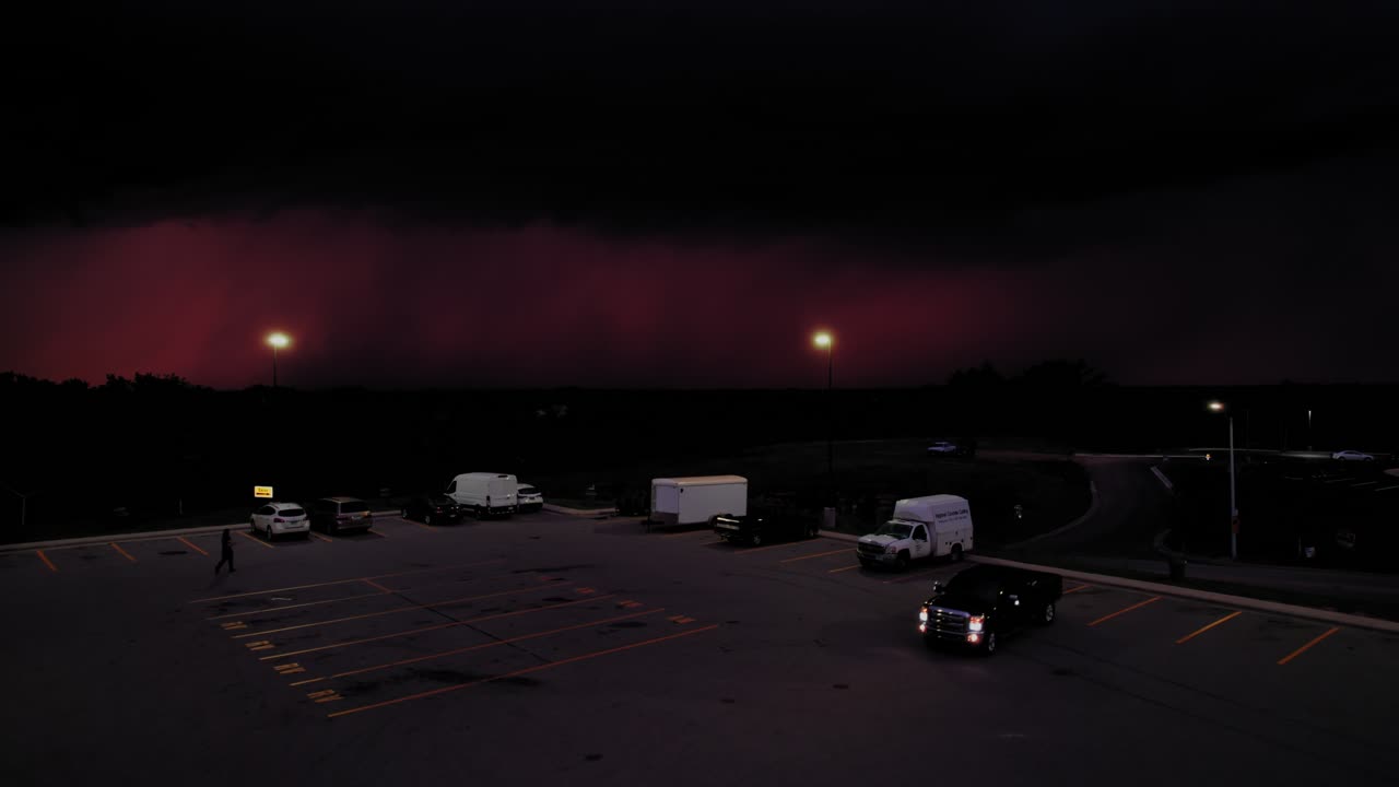 Tense industrial scene at dusk, perfect for enhancing the atmosphere in criminal documentaries with dramatic visuals. Car leaving parking lot